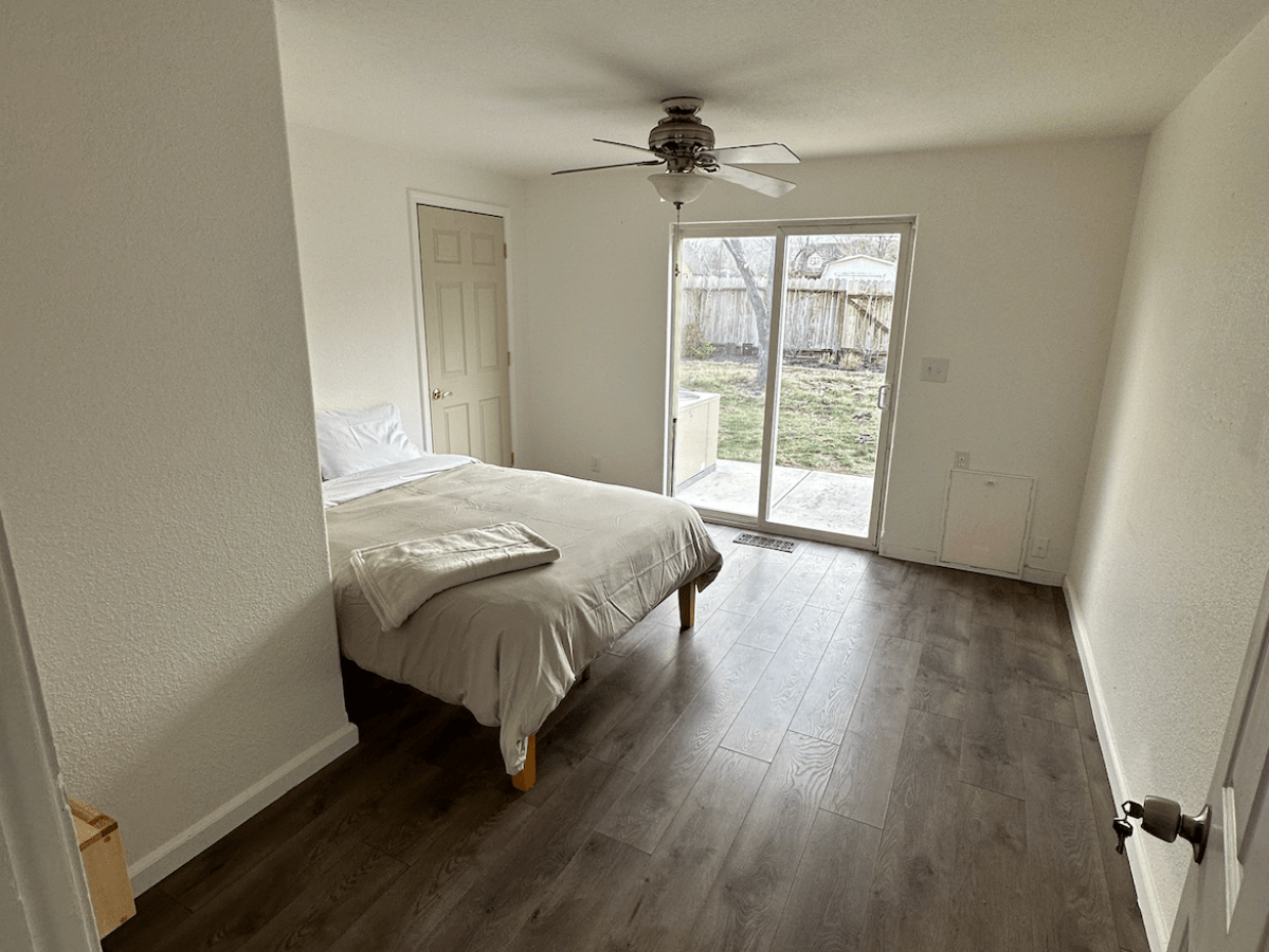 a bedroom with a bed and a mirror